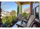 Cozy front porch featuring wooden rocking chairs with brick and stone column accents at 6125 Allison Rd, Cumming, GA 30040
