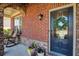 Charming front porch with rocking chairs, brick accents, and a decorative wreath at 6125 Allison Rd, Cumming, GA 30040
