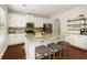 Modern kitchen with stainless steel appliances and a granite island with bar seating at 6125 Allison Rd, Cumming, GA 30040