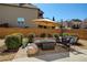 Charming patio with ample seating, an umbrella, and a fire pit table at 6125 Allison Rd, Cumming, GA 30040