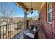 Charming porch with stone pillars, wood deck, and relaxing seating at 6125 Allison Rd, Cumming, GA 30040