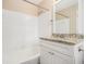 Well-lit bathroom featuring a bathtub, shower, white tile and modern vanity at 1731 Fieldgreen Overlook, Stone Mountain, GA 30088