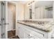 Bathroom featuring double vanity, granite countertops, modern fixtures, and wood-look floors at 1731 Fieldgreen Overlook, Stone Mountain, GA 30088
