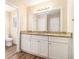 Bathroom with a double vanity, granite countertops, modern fixtures, and hardwood floors at 1731 Fieldgreen Overlook, Stone Mountain, GA 30088