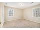 Comfortable bedroom featuring two windows, neutral carpet and an abundance of natural light at 1731 Fieldgreen Overlook, Stone Mountain, GA 30088