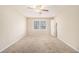 Bedroom with neutral carpet, ceiling fan and a large window creating a bright, airy space at 1731 Fieldgreen Overlook, Stone Mountain, GA 30088