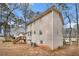 Rear exterior showing a light-colored two story house with large windows and a backyard at 1731 Fieldgreen Overlook, Stone Mountain, GA 30088