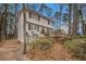 Charming two-story home featuring a wooden deck, landscaped yard, and beautiful greenery at 1731 Fieldgreen Overlook, Stone Mountain, GA 30088