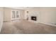 Spacious living room featuring a classic brick fireplace and French doors at 1731 Fieldgreen Overlook, Stone Mountain, GA 30088