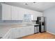 Bright kitchen with white cabinets, granite countertops, and stainless steel appliances at 279 Scarborough Rd, Stockbridge, GA 30281