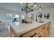 Spacious kitchen island with quartz countertop offering seating, storage, and view into adjoining living space at 405 Carrera Ln, Acworth, GA 30102