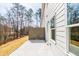 Backyard exterior with concrete patio, showing siding, window, fence, and surrounding trees at 412 Carrera Ln, Acworth, GA 30102
