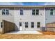 Rear exterior shows a concrete patio, gray siding, trimmed windows, and a backyard lawn at 412 Carrera Ln, Acworth, GA 30102