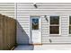 Backyard with a white door, gray siding, fence, and concrete patio at 412 Carrera Ln, Acworth, GA 30102