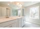 Sun-filled bathroom featuring a double vanity with elegant finishes, a window, and a glass shower at 412 Carrera Ln, Acworth, GA 30102