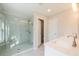 Bright bathroom featuring a glass shower, double sink, and elegant white marble countertops at 412 Carrera Ln, Acworth, GA 30102