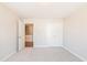 Bedroom with neutral carpet and walls, showing closet and doorway to the hallway at 412 Carrera Ln, Acworth, GA 30102