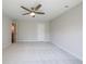 Large bedroom with a ceiling fan, light-colored carpet, and a view into an attached bathroom at 412 Carrera Ln, Acworth, GA 30102