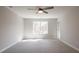 Spacious bedroom features a ceiling fan and a bright window overlooking the outdoor landscape at 412 Carrera Ln, Acworth, GA 30102