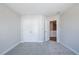 Well-lit bedroom with neutral carpet, double door closet, and an open door to the hallway at 412 Carrera Ln, Acworth, GA 30102