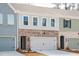 Charming townhome exterior featuring a brick facade and attached garage at 412 Carrera Ln, Acworth, GA 30102