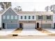 A row of charming townhomes with well-maintained landscaping and driveways at 412 Carrera Ln, Acworth, GA 30102