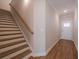 View of the hallway with a staircase and wood flooring that leads to a white front door at 412 Carrera Ln, Acworth, GA 30102