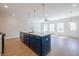 Open-concept kitchen featuring an island with sink and view into the living area at 412 Carrera Ln, Acworth, GA 30102