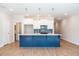 Stylish kitchen featuring a blue island, white cabinets, and stainless steel appliances at 412 Carrera Ln, Acworth, GA 30102