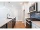 Bright kitchen with stainless steel appliances, island sink, and stylish pendant lighting at 412 Carrera Ln, Acworth, GA 30102