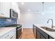 Modern kitchen featuring stainless steel appliances, a white countertop, and hardwood floors at 412 Carrera Ln, Acworth, GA 30102