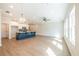 Open-concept living room with a spacious kitchen, an island, hardwood floors and modern lighting at 412 Carrera Ln, Acworth, GA 30102