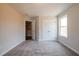 Bedroom with a closet and door, carpeted floor, and neutral walls at 417 Carrera Ln, Acworth, GA 30102