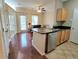 Open kitchen features a black countertop, stainless steel dishwasher and hardwood floors at 4333 Dunwoody Park # 1202, Atlanta, GA 30338