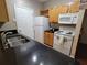 Kitchen featuring granite counters, white appliances and wine rack at 4333 Dunwoody Park # 1202, Atlanta, GA 30338