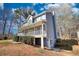 Charming two-story home featuring a covered front porch, and inviting curb appeal, nestled on a landscaped lot with mature trees at 1230 Scenic Brook Sw Trl, Conyers, GA 30094
