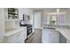 Kitchen featuring granite countertops, stainless steel appliances, and white cabinets at 1230 Scenic Brook Sw Trl, Conyers, GA 30094