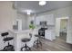 Inviting kitchen with a breakfast bar, stainless steel appliances, white cabinetry, and modern lighting at 1230 Scenic Brook Sw Trl, Conyers, GA 30094