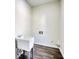 Bright laundry room featuring a utility sink and durable vinyl flooring at 1230 Scenic Brook Sw Trl, Conyers, GA 30094