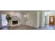 Inviting living room with a fireplace, seamlessly blending into a staircase and entryway to create a harmonious and welcoming atmosphere at 1230 Scenic Brook Sw Trl, Conyers, GA 30094