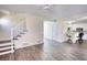 Open-concept living room featuring modern flooring that connects the living, dining, and kitchen areas creating a warm and inviting atmosphere at 1230 Scenic Brook Sw Trl, Conyers, GA 30094