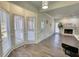 Bright living room with luxury vinyl plank flooring, fireplace and mantel, and large bay window at 1230 Scenic Brook Sw Trl, Conyers, GA 30094