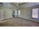 Spacious main bedroom featuring a trey ceiling, carpeted floors, and natural light from multiple windows at 1230 Scenic Brook Sw Trl, Conyers, GA 30094