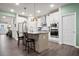 Bright kitchen with a large island, stainless steel appliances, white cabinets, and modern pendant lighting at 790 Riverwood Pass, Dallas, GA 30157