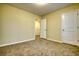 A simple bedroom features neutral carpeting, yellow walls, and white trim and doors at 8138 Brookbend Dr, Douglasville, GA 30134