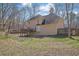 A two-story home showcasing a large backyard and wooden deck at 3109 Wynford Gables Sw, Marietta, GA 30064