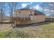 Home's rear exterior featuring a spacious deck overlooking a large yard with mature trees at 3109 Wynford Gables Sw, Marietta, GA 30064