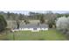 Aerial view of property with a well-maintained lawn, a long driveway, and mature trees at 349 Asa Moseley Rd, Stockbridge, GA 30281