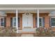 Inviting front door and entrance, with a classic brick facade and stately columns at 349 Asa Moseley Rd, Stockbridge, GA 30281