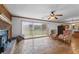 Living room with brick fireplace, ceiling fan, sliding glass doors to yard, and unique stone flooring at 349 Asa Moseley Rd, Stockbridge, GA 30281